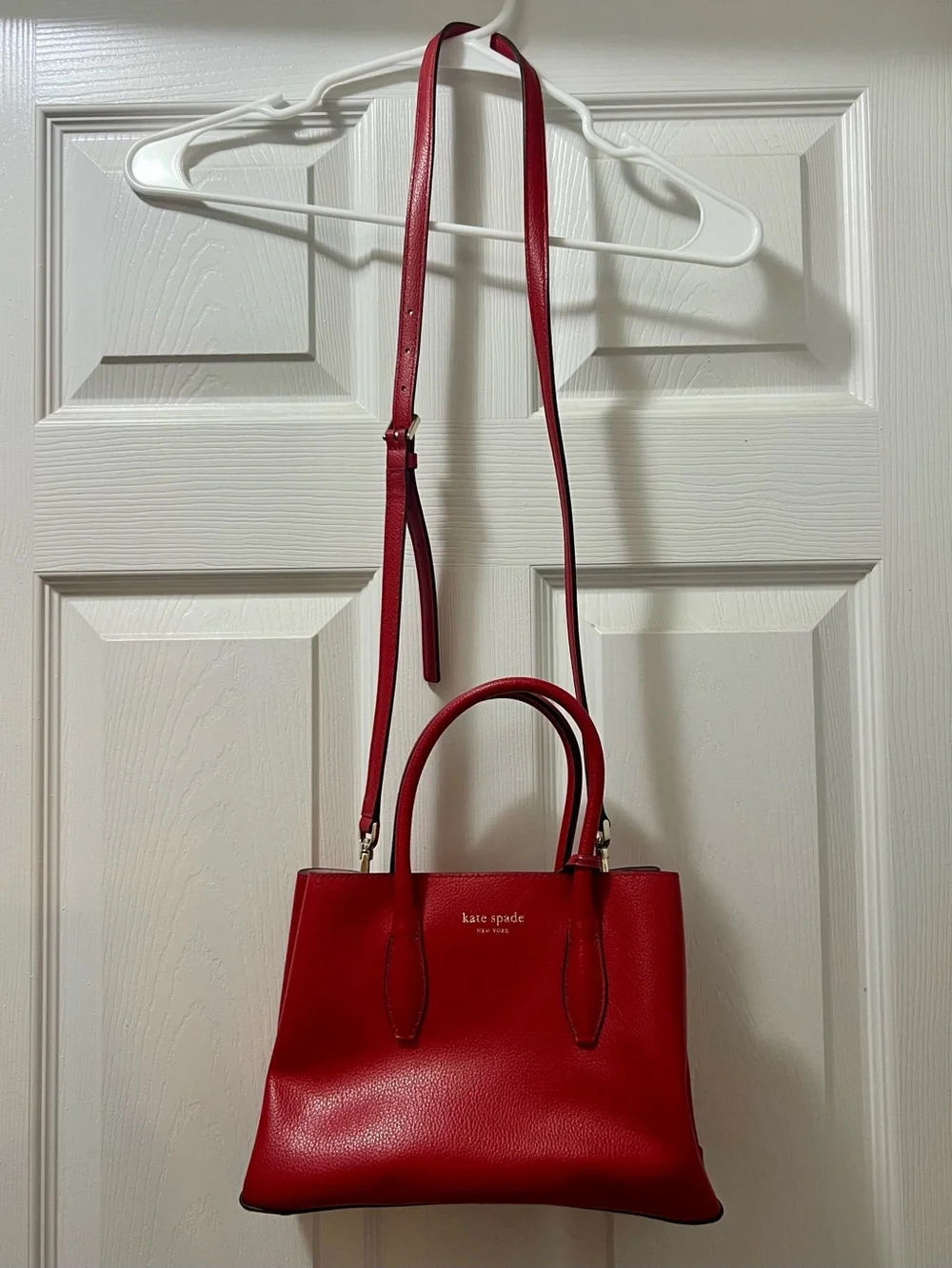 kate spade red leather satchel with top handles and adjustable crossbody strap